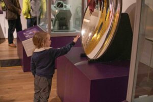 A young child investigating one of the exhibits