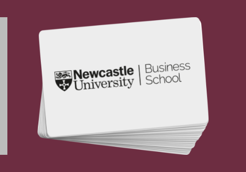 Image of stack of business cards with the Newcastle Business School logo on the top card
